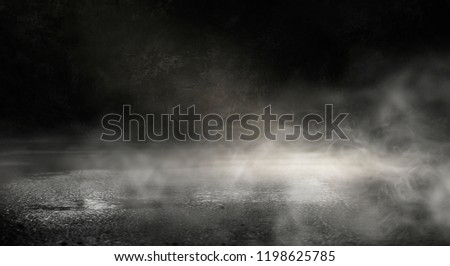 Background of an empty dark street, wet asphalt.