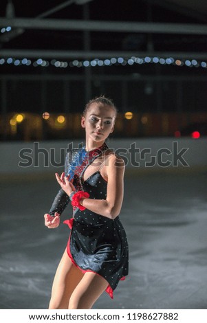 This young ice skater's movement is brilliant. She performs beautifully. 