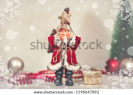 Santa Claus toy holds a staff with a star and a Christmas tree on a background of beige snowy night bokeh and blurred lights in the background Concept Happy New Year Copy space Banner, poster Flat lay