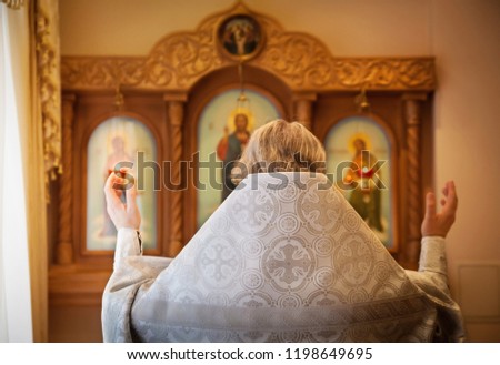 the priest turned to the icons and reads a prayer