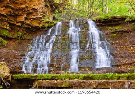 Beautiful waterfall on a mountain stream in the woods
