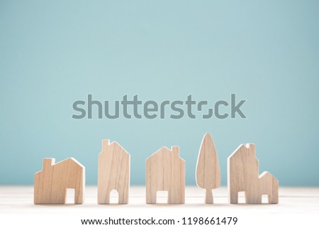 Close up diffirance wood house model on blue background, Choose home the best for you, Planning to buy property.