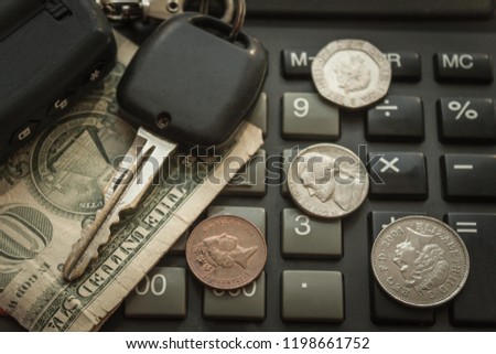Car keys, small money on a calculator. Rising gasoline prices, the cost of repairs and maintenance of the machine. Vignetting, top view.