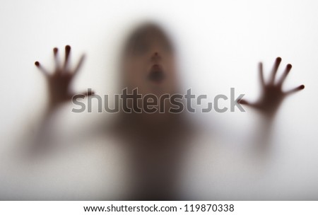 a girl  silhouette behind a  transparent  paper