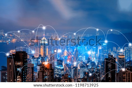 Digital network connection lines of Hong Kong Downtown and Victoria Harbour. Financial district in smart city in technology concept. Skyscraper and high-rise buildings. Aerial view at night.