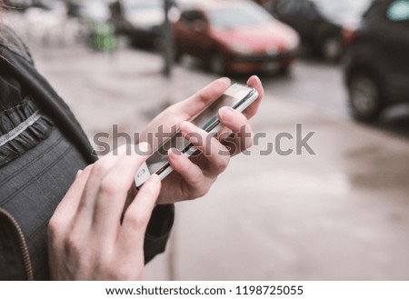 Woman using a smartphone in the street