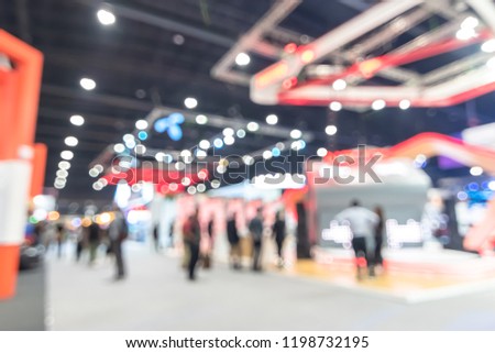 Exhibition event hall blur background of trade show business, world or international expo showcase, tech fair, with blurry exhibitor tradeshow booth displaying product with people crowd Royalty-Free Stock Photo #1198732195