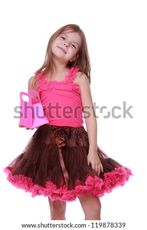 Picture of beautiful little girl with small pink shopping bag on white background