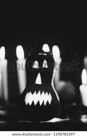 Jack-o-lantern in smoke among burning candles and apples. Halloween holiday, national, tradition. atmospheric photo. harvest day, autumn