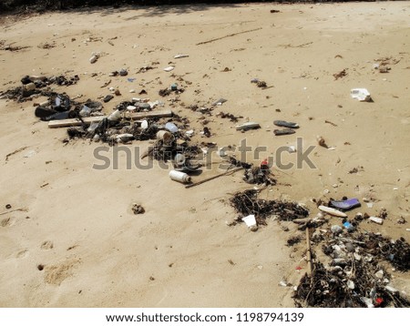 close up trash and pollution on sandy beach