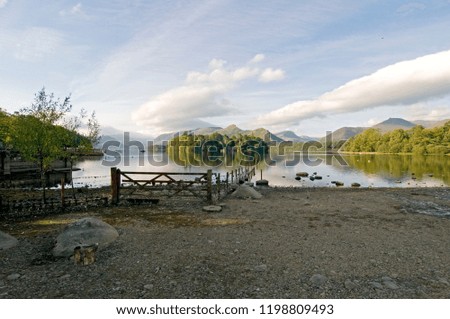 Calm Derwent Water on a summers morning with gate, Lake District, Cumbria England