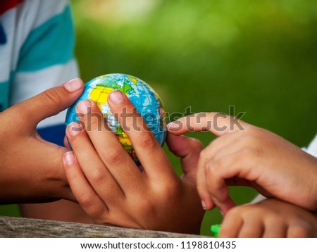 A boy with a ball of the world or planet Earth in his hands. Ecology concept Royalty-Free Stock Photo #1198810435