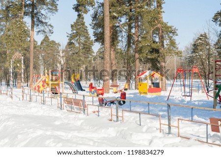 Children's playground in the winter park. Children's Playground in the city Park. Sunny winter's day.