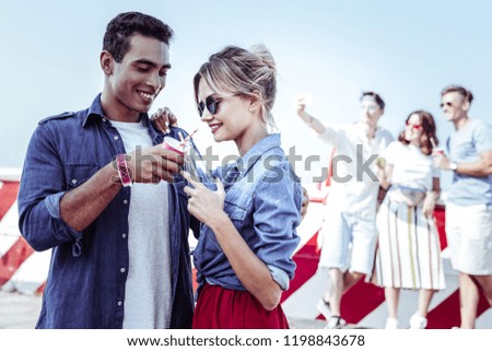 International couple. Charming girl expressing positivity while being deep in thoughts