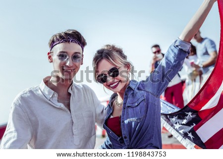 Waiting for you. Cheerful couple expressing positivity while looking forward