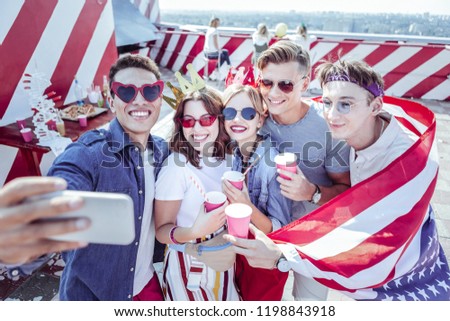 Will miss you. Young male person demonstrating American flag while celebrating independence day