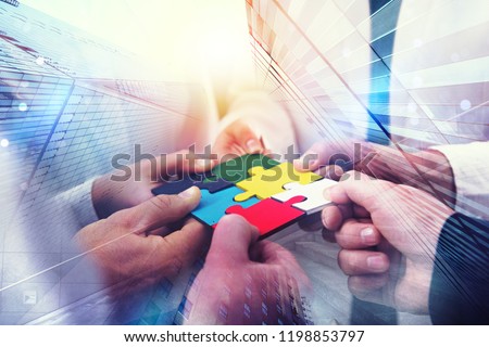 Business people join puzzle pieces in office. Concept of teamwork and partnership. double exposure with light effects Royalty-Free Stock Photo #1198853797
