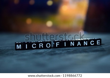 Micro Finance on wooden blocks. Business and finance concept. Cross processed image with bokeh background Royalty-Free Stock Photo #1198866772