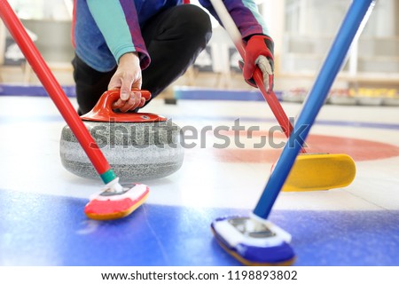 Curling, team playing on the ice. Royalty-Free Stock Photo #1198893802