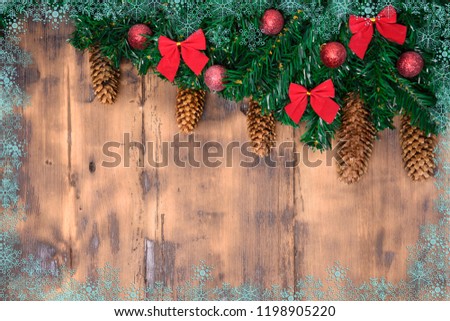 Decorated wooden background with Christmas tree branches with cone. New Year card
