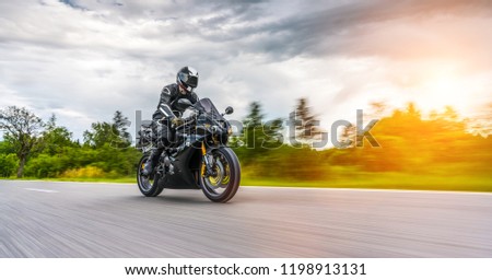 motorbike on the road riding. having fun driving the empty road on a motorcycle tour journey. copyspace for your individual text. Royalty-Free Stock Photo #1198913131
