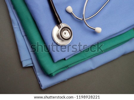 Stethoscope on clothes of nurse, conceptual image