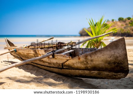 Madagascan pirogue boat on the beach on Nosy Be, Madagascar. Blurred background. Royalty-Free Stock Photo #1198930186