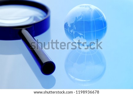 
Earth and magnifying glass