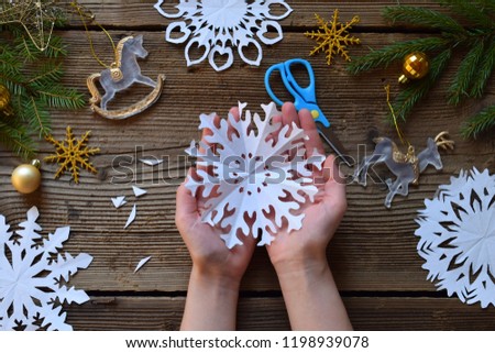 Making paper snowflakes with your own hands. Children's DIY. Merry Christmas and New Year concept.