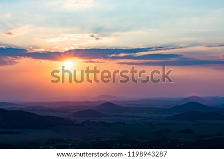 Landscape with the sunset. Orange enlightened cloud clouds and dark landscape. Royalty-Free Stock Photo #1198943287
