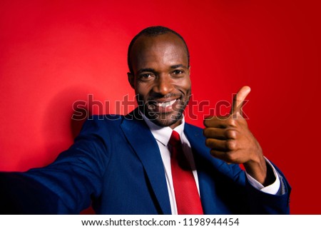 Confident nice glad chic cool positive worker in suit style blue jacket tux tuxedo formal wear show thumbs up after hard job work take selfie on front camera smartphone isolated on red shine