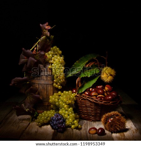 Autumnal still life with grapes and chestnuts
