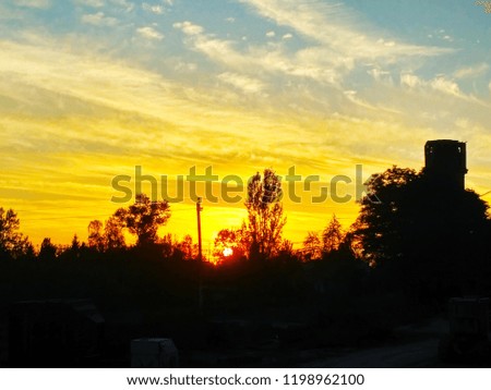 Enchanting sunset in the countryside. Incredibly beautiful combination of colors of the sky and clouds. The play of light at sunset. Dramatic scenic sunset atmospheric photo