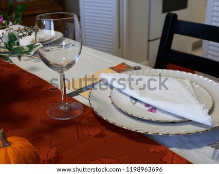 Fancy dinnerware, wine glass and plates at an elegant dinner table