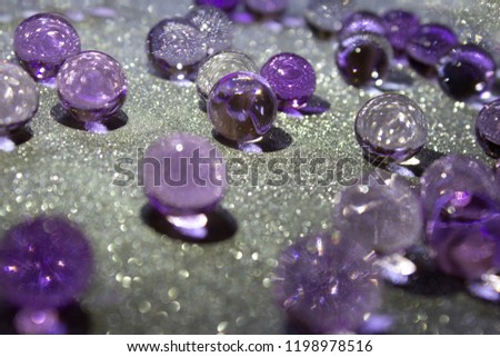 Purple gel on light silver material, macro soft focus. Beautiful  holiday classic violet background. Christmas, New Year or Wedding wallpaper. Copy space 