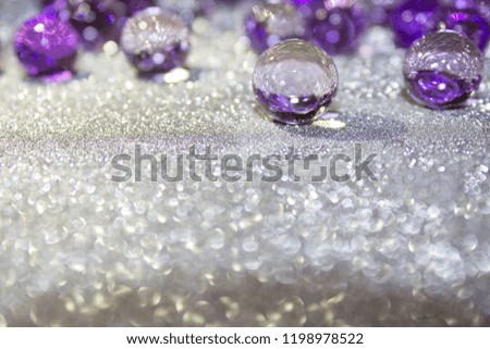 Purple gel on light silver material, macro soft focus. Beautiful  holiday classic violet background. Christmas, New Year or Wedding wallpaper. Copy space 
