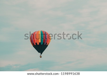 Hot air balloon takes flight during sunrise at a hot air balloon festival Royalty-Free Stock Photo #1198991638