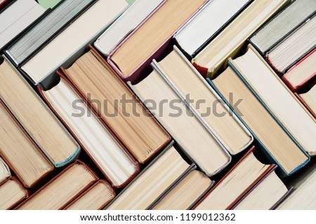 Many Books Piles. Hardback books on wooden table. Back to school. Copy space Royalty-Free Stock Photo #1199012362