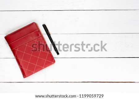 Top view of working object. Red agenda and pen
