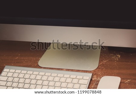 computer and keyboard on wood table