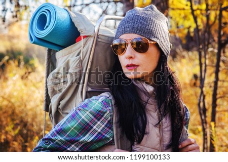 Active lifestyle. Portrait of  beautiful young woman in sunglasses. Tourist with  large backpack.