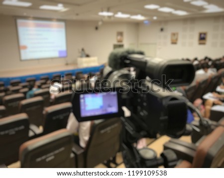 Video camcorder or video camera recording lecturer live in seminar hall or ted talk business people community. Education or seminar concept blur image use for background.