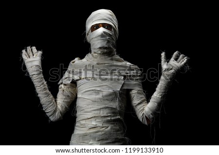 Studio shot portrait  of young man in costume  dressed as a halloween  cosplay of scary mummy pose like a frightened acting on isolated black background.