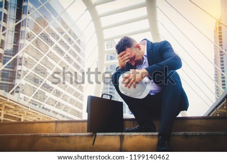 Businessman sitting sadly : Most stresses in the world are come from work.