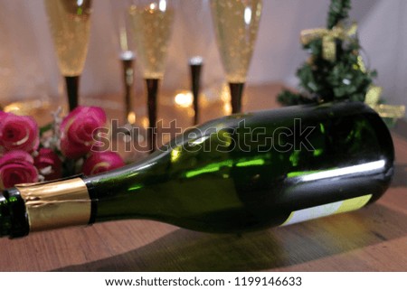 Champagne and bottle, roses and Christmas tree