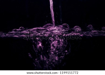 Purple Water Splash Motion on Black Background ,Selective Focus.