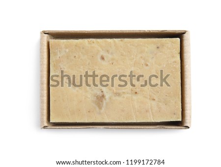Hand made soap bar in cardboard package on white background, top view
