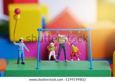 Miniature people : Children  and student standing on color wooden block. 
 Picture use for education, holiday and children's day concept.