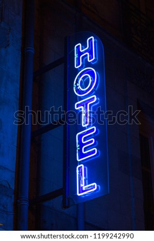 Blue neon hotel sign in the night