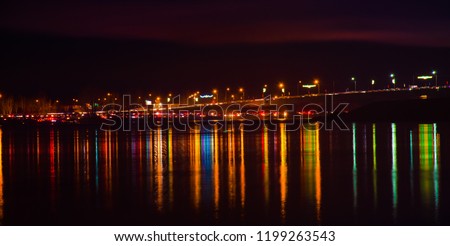 Blurred city lights with bokeh effect reflected on water